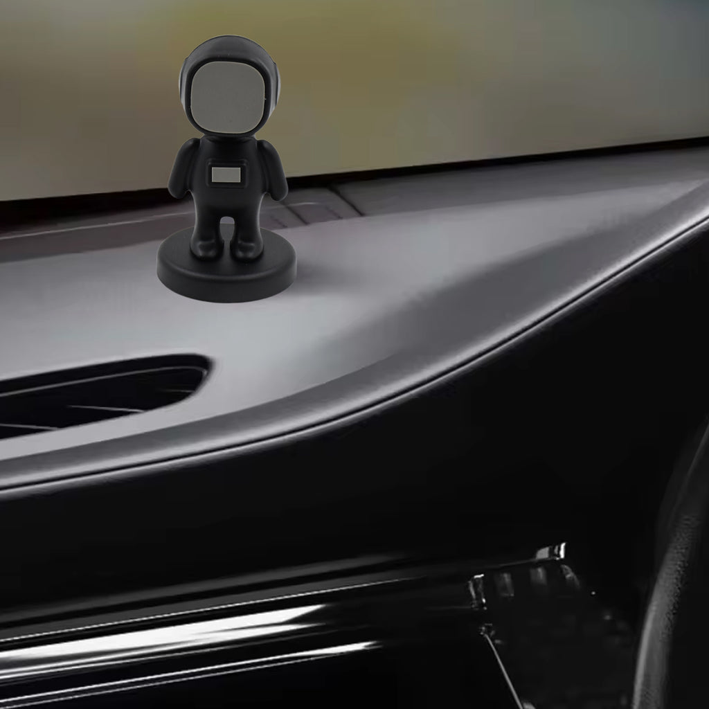 Astronaut magnetic phone holder attached to car dashboard