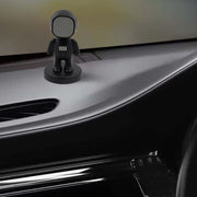 Astronaut magnetic phone holder attached to car dashboard