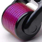 A close-up view of the magenta micro-needle head on a black derma roller, showing numerous tiny needles.