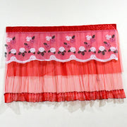 Full view of the red lace TV cover with floral embroidery on a white background.